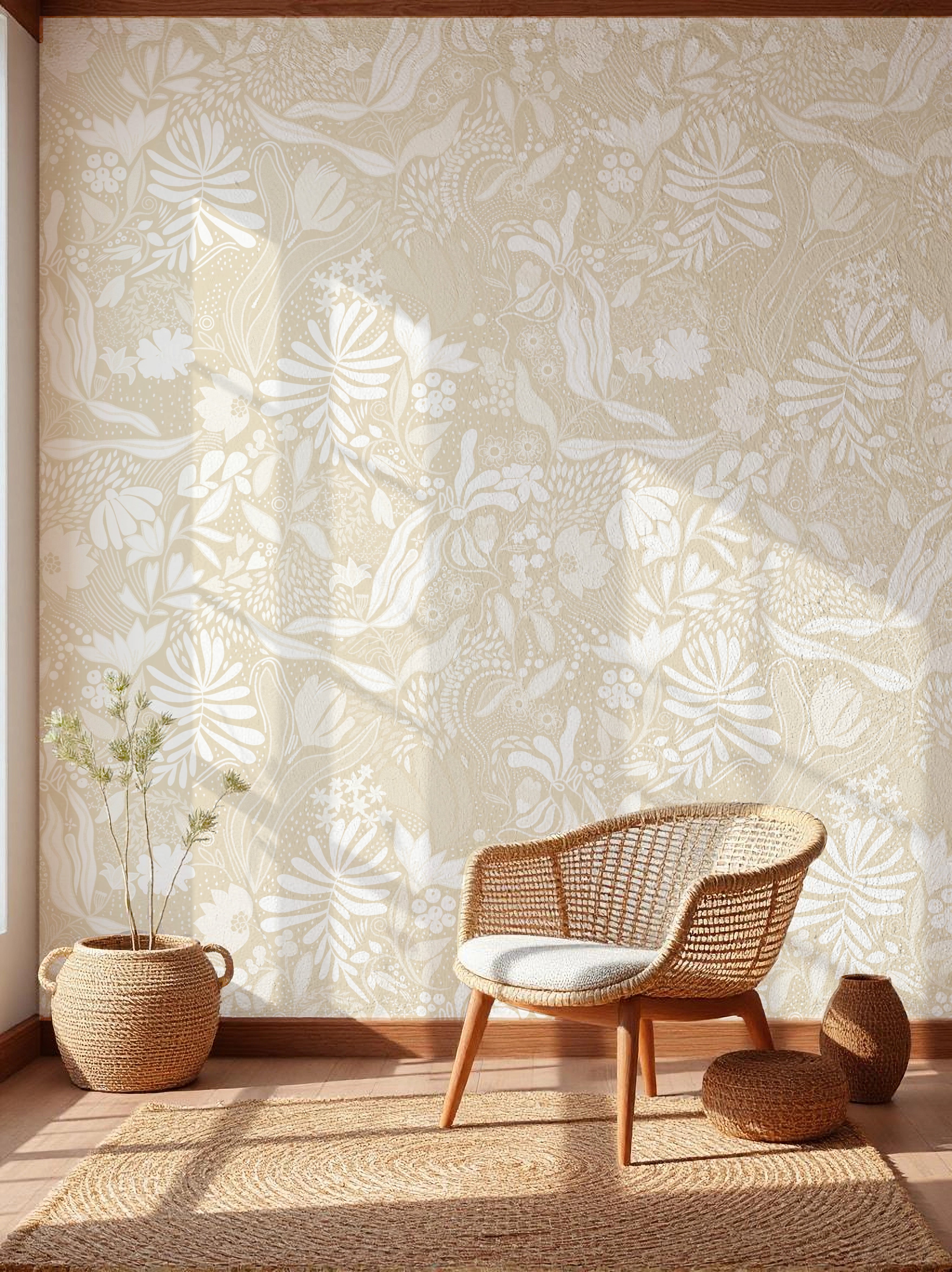 Wicker chair and ottoman against a wall with floral wallpaper